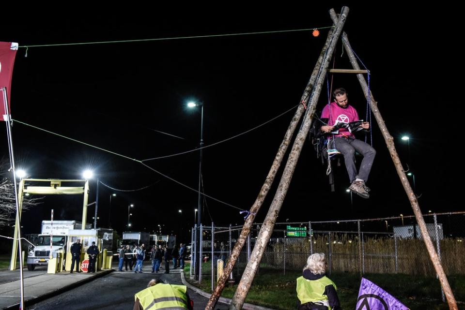 Climate activist group Extinction Rebellion at a blockade in front of the New York Times printing plant in the Flushing neighborhood of Queens on April 22, 2022 (Getty Images)