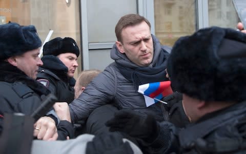 Alexei Navalny is detained at a 28 January rally calling for an election boycott - Credit: Evgeny Feldman/AP