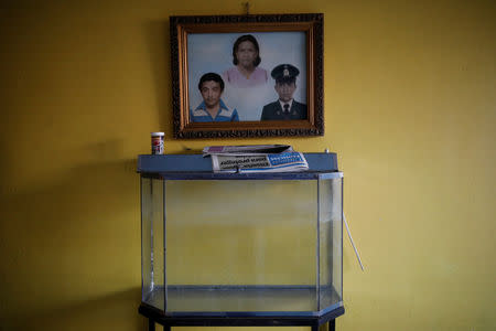 A fish food container stands on top of an empty fish tank at the house of David Riveros, who lives on the 1st floor of an apartment block in downtown Caracas, Venezuela, March 19, 2019. Riveros, 62, a retired bus driver said, "I ran out of water, today I finished all that I had stored". REUTERS/Carlos Garcia Rawlins