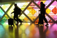 Travelers walk through Miami International Airport ahead of the Thanksgiving holiday, Wednesday, Nov. 22, 2023, in Miami. (AP Photo/Lynne Sladky)