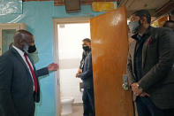 Errick L. Greene, superintendent of the Jackson, Miss., Public Schools, left, tells both EPA Administrator Michael Regan, center, and Jackson Mayor Chokwe Antar Lumumba, right, how the city's water problems affects many of the city's schools, including Wilkins Elementary School, Monday, Nov. 15, 2021. Regan and others toured the school, as part of the agency's "Journey to Justice" tour through Mississippi, Louisiana and Texas, spotlighting longstanding environmental concerns in historically marginalized communities. (AP Photo/Rogelio V. Solis)