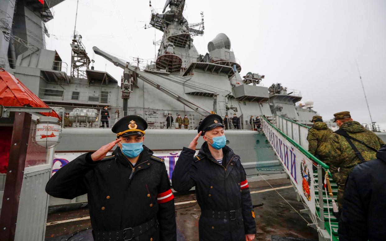 Russian sailors stand guard at the Northern Fleet's flagship, the Peter the Great missile cruiser, at its Arctic base Severomorsk - AP Photo/Alexander Zemlianichenko