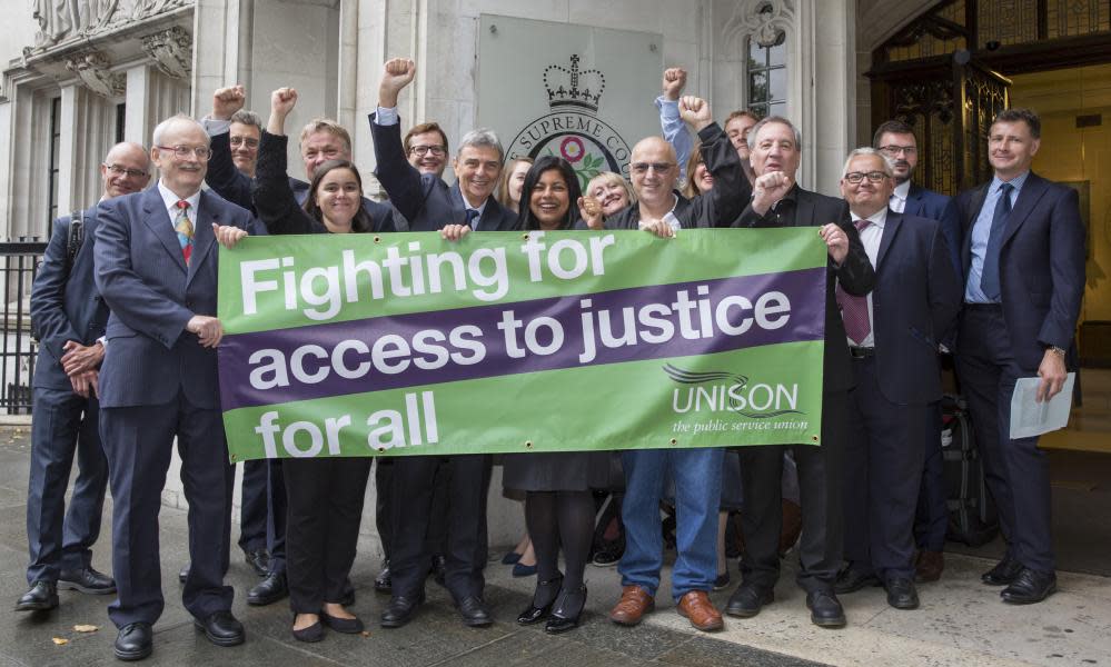 Unison members hold a banner reading 'Fighting for access to justice for all'