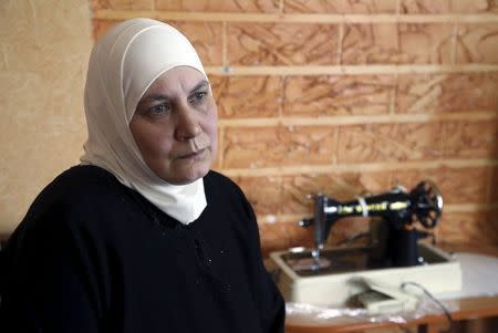 Fawziyeh, a 52-year-old Syrian woman, attends an interview with Reuters at her house in a small town south of Beirut, Lebanon April 15, 2015. REUTERS/Aziz Taher