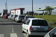 Motorists queue to refuel their vehicles at a petrol station in Combourg, western France, on May 24, 2016, following blockades of several oil refineries and fuel depots