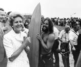 In this Aug. 18, 1971, image provided by the Richard Nixon Presidential Library and Museum, then-first lady Pat Nixon talks with people in San Diego while people across the border, marked by a barbed wire fence, watch from the Tijuana, Mexico, side during the dedication of Friendship Park. In the days before Joe Biden became president, construction crews worked quickly to finish Donald Trump's wall at an iconic cross-border park overlooking the Pacific Ocean that then-first lady Pat Nixon inaugurated in 1971 as a symbol of international friendship. Biden on Wednesday, Jan. 20, 2021, ordered a "pause" on all wall construction within a week, one of 17 executive edicts issued on his first day in office, including six dealing with immigration. (Courtesy of Richard Nixon Presidential Library and Museum via AP)
