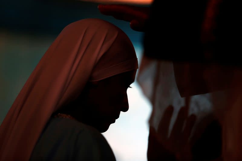 A member of the Christian evangelical church Israelite Mission of the New Universal Pact attends a worship service at the group’s main temple, on the outskirts of Lima