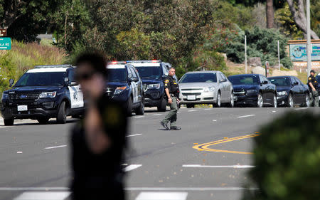 A San Diego Sheriff’s Deputy walks near the scene of a shooting incident at the Congregation Chabad synagogue in Poway, north of San Diego, California, U.S. April 27, 2019. REUTERS/John Gastaldo