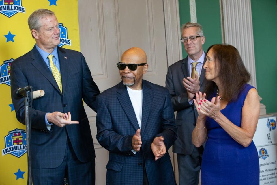 Darrell Washington, center, is named the state's first VaxMillions winner in July 2021. He's shown with Gov. Charlie Baker, Lottery Director Michael Sweeney, rear, and Treasurer Deborah Goldberg.