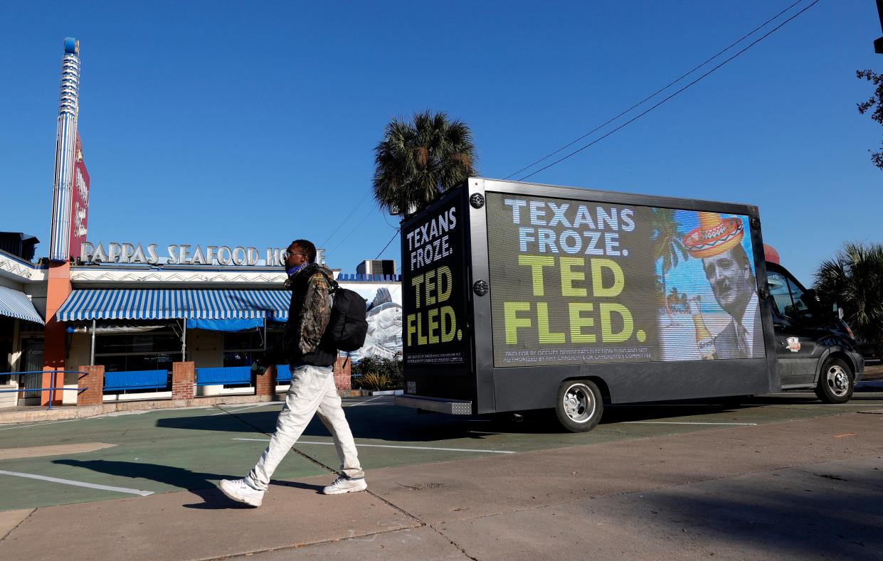 <p>A pedestrian walks by a digital billboard truck with an image of U.S. Sen. Ted Cruz (R-TX) as it sits in a parking lot near Senator Cruz's home on February 19, 2021 in Houston, Texas. </p> (Photo by Justin Sullivan/Getty Images)
