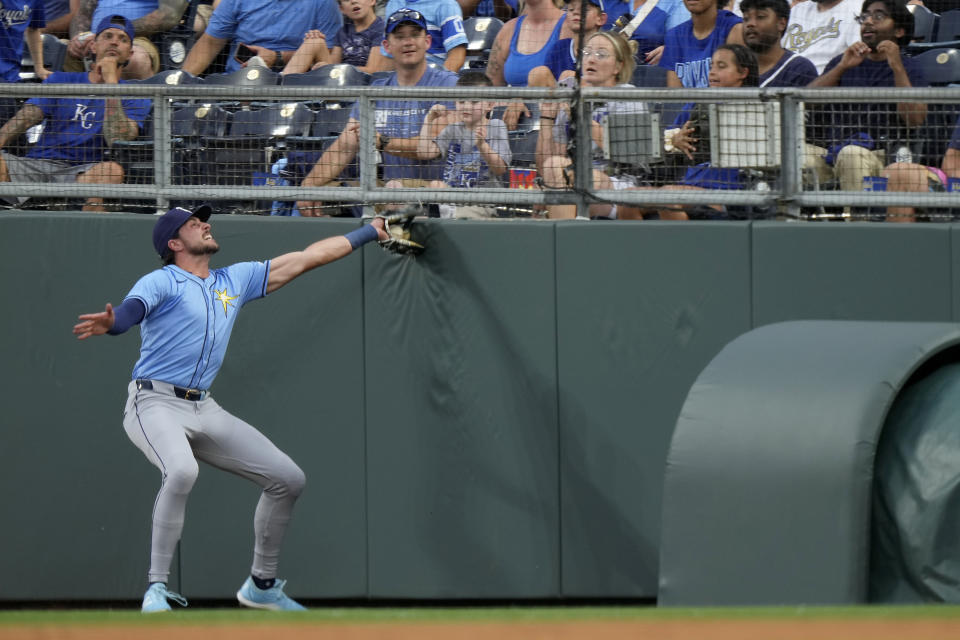 Tampa Bay Rays right fielder Josh Lowe catches a fly foul ball for the out on Kansas City Royals' Bobby Witt Jr. during the first inning of a baseball game Tuesday, July 2, 2024, in Kansas City, Mo. (AP Photo/Charlie Riedel)