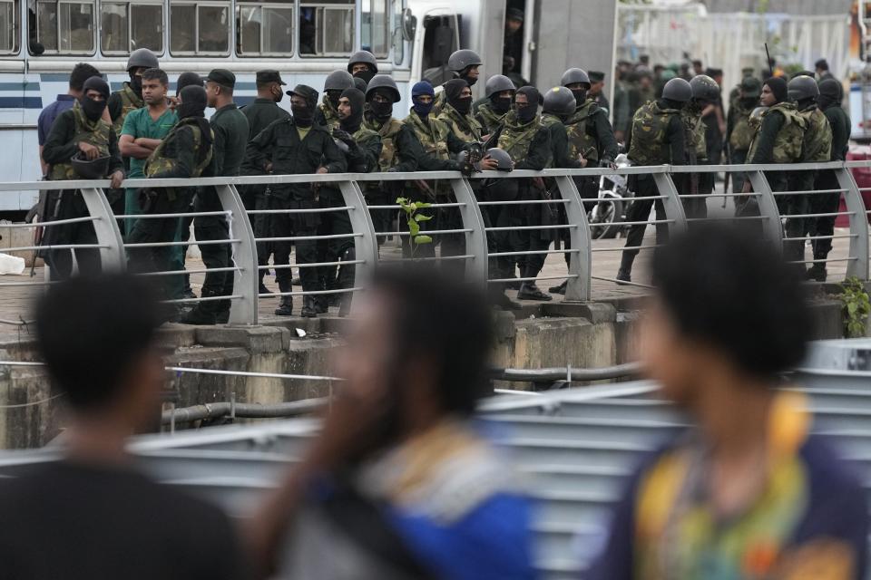 Army soldiers stand guard near a barricade following an eviction of protesters from the presidential secretariat premise in Colombo, Sri Lanka, Friday, July 22, 2022. (AP Photo/Eranga Jayawardena)