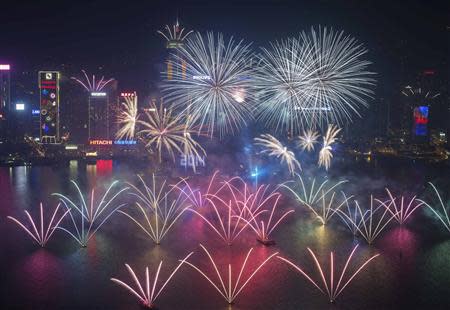 Fireworks explode over Victoria Harbour and Hong Kong Convention and Exhibition Centre during a pyrotechnic show to celebrate the New Year in Hong Kong