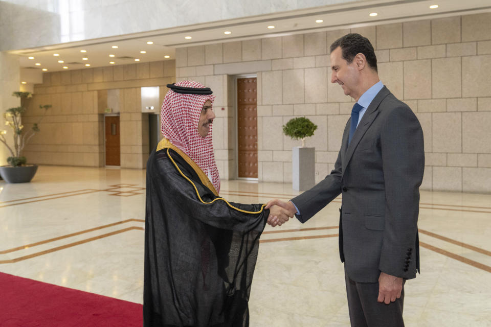 FILE - In this photo released by the Syrian official news agency SANA, Syrian President Bashar Assad, right, welcomes Saudi Minster of Foreign Affairs Faisal bin Farhan, left, before their meeting in Damascus, Syria, Tuesday, April 18, 2023. With momentum moving toward a likely readmission of Syria to the Arab League, Syrians in government-held areas are hoping that political normalization will ease an economic crisis and lead to foreign investment and better living conditions. (SANA via AP, File)