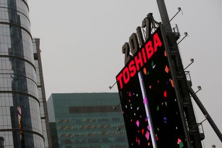 FILE PHOTO - Workers prepare the New Year's eve numerals above a Toshiba sign in Times Square in Manhattan, New York City, U.S., December 26, 2016. REUTERS/Andrew Kelly/File Photo