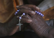 An Indian Catholic Christian woman holds a rosary and prays on Ash Wednesday at Saint Mary's Basilica in Hyderabad, India, Wednesday, Feb. 26, 2020. The Ash Wednesday marks the beginning of Lent, a solemn period of 40 days of prayer and self-denial leading up to Easter.(AP Photo/Mahesh Kumar A.)