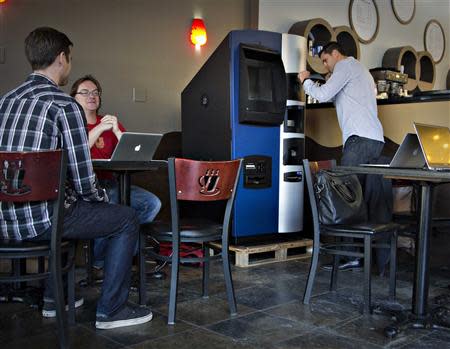 Vancouver Bitcoiniacs Trading Company co-founder Mitchell Demeter prepares, according to him, the first bitcoin ATM machine in a Waves Coffee House in Vancouver, British Columbia October 28, 2013. REUTERS/Andy Clark