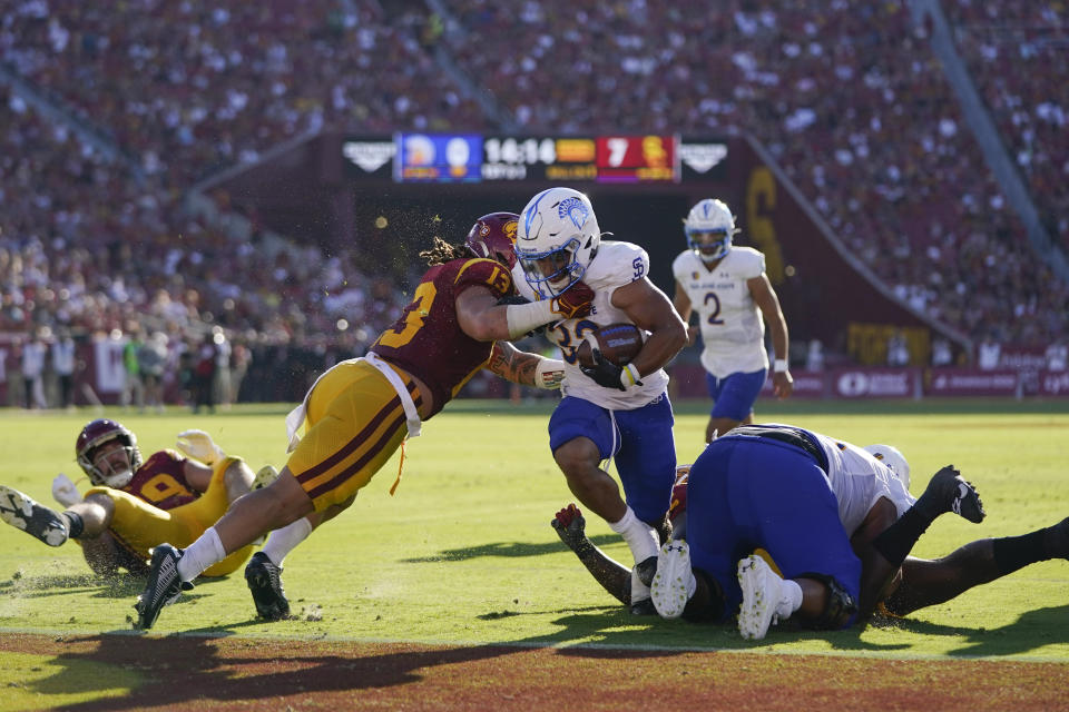 San Jose State running back Kairee Robinson (32) scores a touchdown against Southern California linebacker Mason Cobb (13) during the first half of an NCAA college football game in Los Angeles, Saturday, Aug. 26, 2023. (AP Photo/Jae C. Hong)