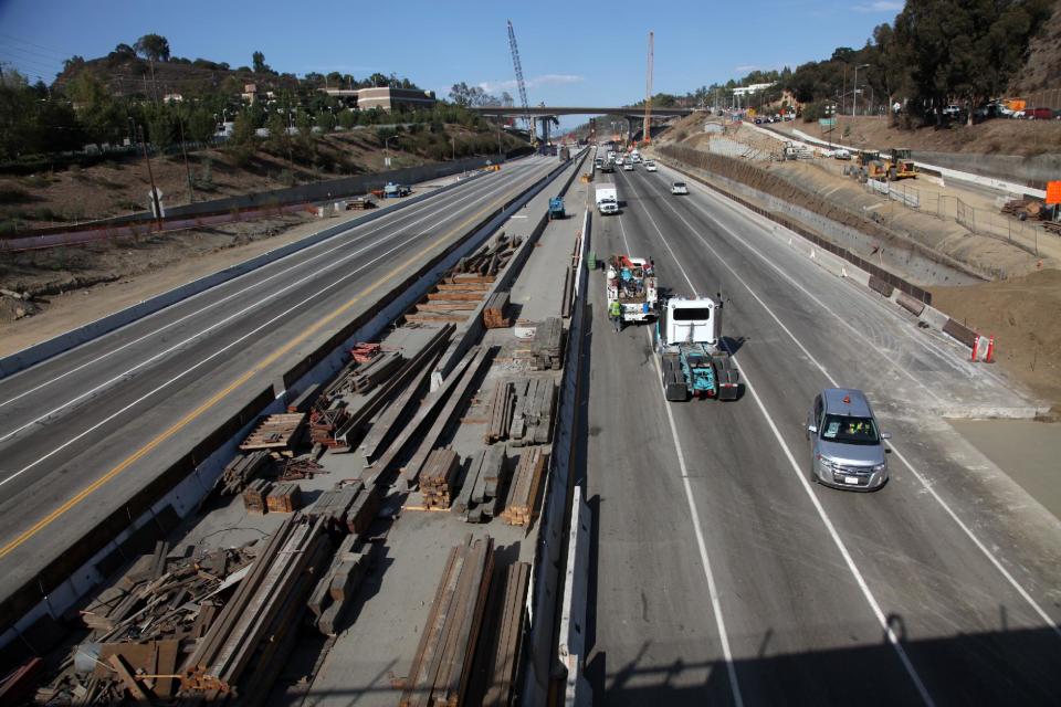 Workers continue the demolition of the center span of the Mulholland Drive bridge along a closed Interstate 405 in Los Angeles on Saturday Sept. 29,2012. Construction crews are on schedule and traffic tie-ups are minimal in Los Angeles, making for a smooth start to Carmageddon II, the sequel to last year's shutdown of one of the nation's busiest freeways. (AP Photo/Richard Vogel)