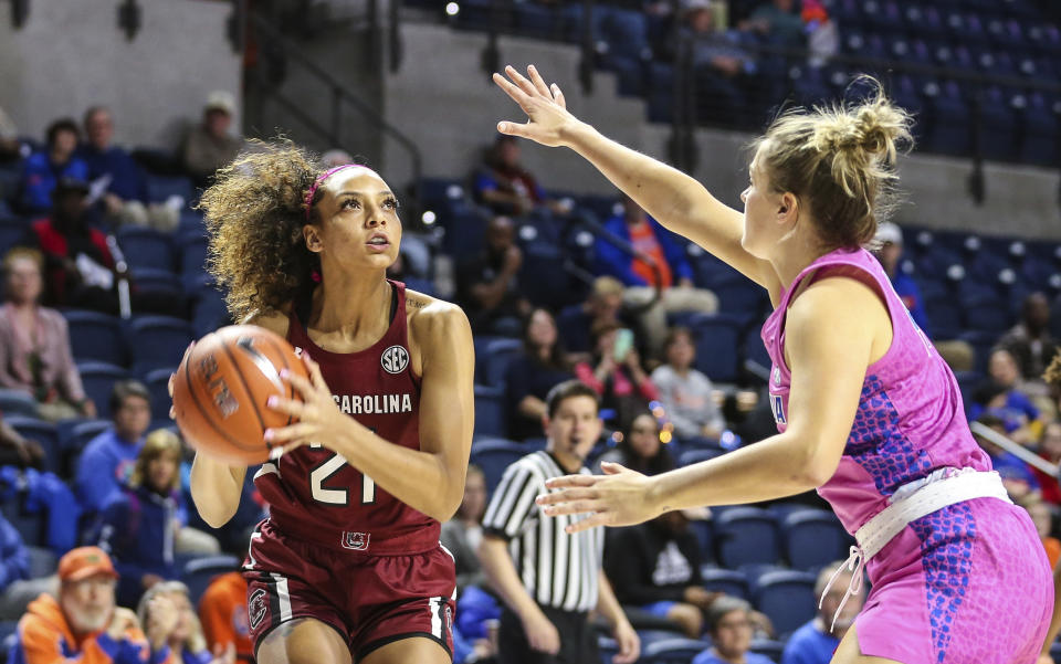 South Carolina forward Mikiah Herbert Harrigan (21) looks to shoot while defended by Florida guard Kristina Moore (14) during the first half of an NCAA college basketball game Thursday, Feb. 27, 2020, in Gainesville, Fla. (AP Photo/Gary McCullough)