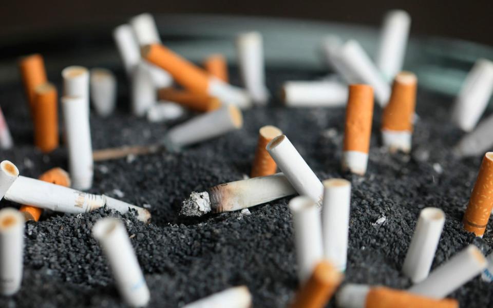 Cigarette butts in an ashtray  - Jenny Kane/AP