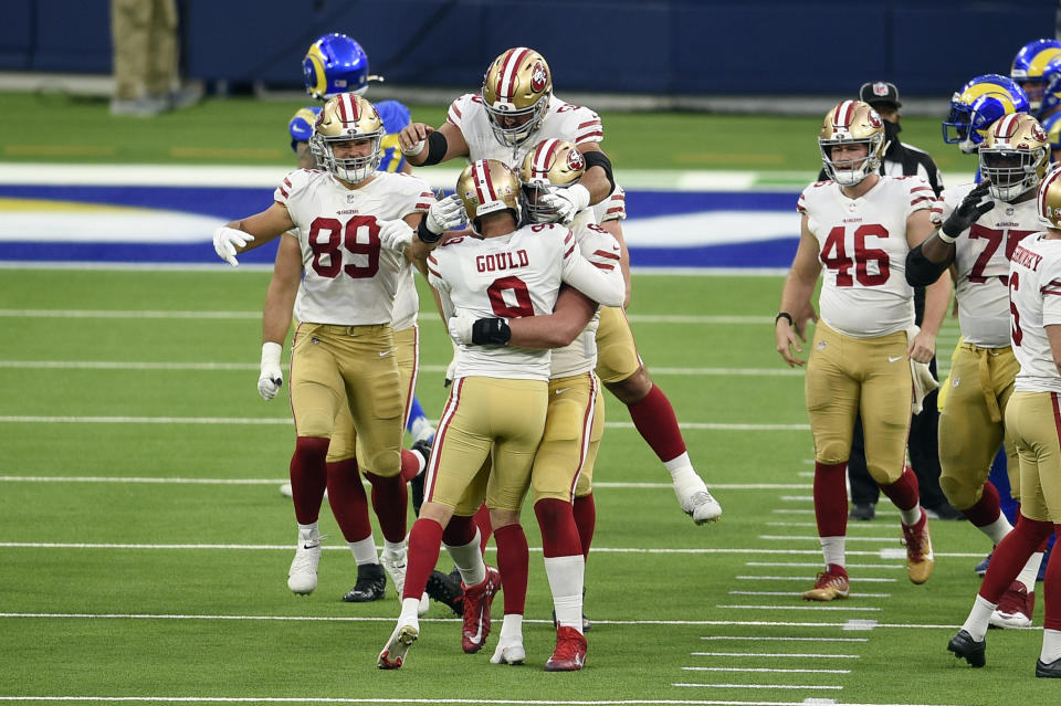 San Francisco 49ers kicker Robbie Gould (9) is hugged by teammates after making the game-winning field goal as time expires during the second half of an NFL football game against the Los Angeles Rams Sunday, Nov. 29, 2020, in Inglewood, Calif. San Francisco won 23-20. (AP Photo/Kelvin Kuo)