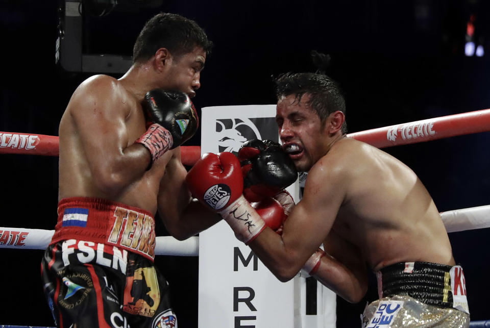 Roman Gonzalez, left, punches Moises Fuentes during their bantamweight boxing match, Saturday, Sept. 15, 2018, in Las Vegas. Gonzalez won by TKO. (AP Photo/Isaac Brekken)