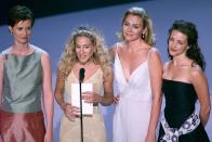 <p>The stars of <em>Sex and the City–</em>Cynthia Nixon, Sarah Jessica Parker, Kim Cattrall, and Kristin Davis–present an award. The show had just wrapped its second season, eventually landing seven Emmy wins during its entire six season run.</p>