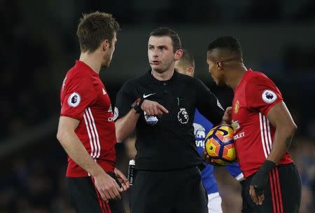 Football Soccer Britain - Everton v Manchester United - Premier League - Goodison Park - 4/12/16 Manchester United's Antonio Valencia and Michael Carrick speak with referee Michael Oliver Reuters / Andrew Yates Livepic