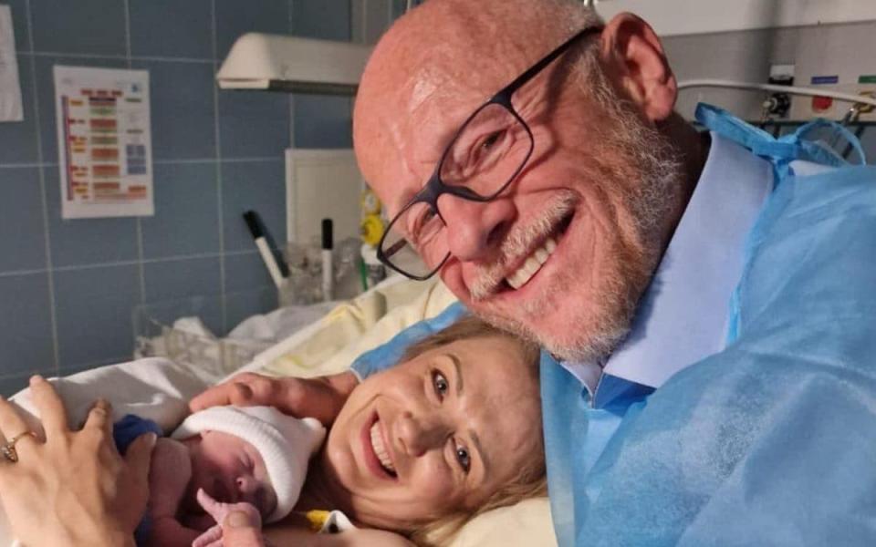 John Caudwell with partner Modesta and baby daughter Isabella. - twitter.com/johndcaudwell
