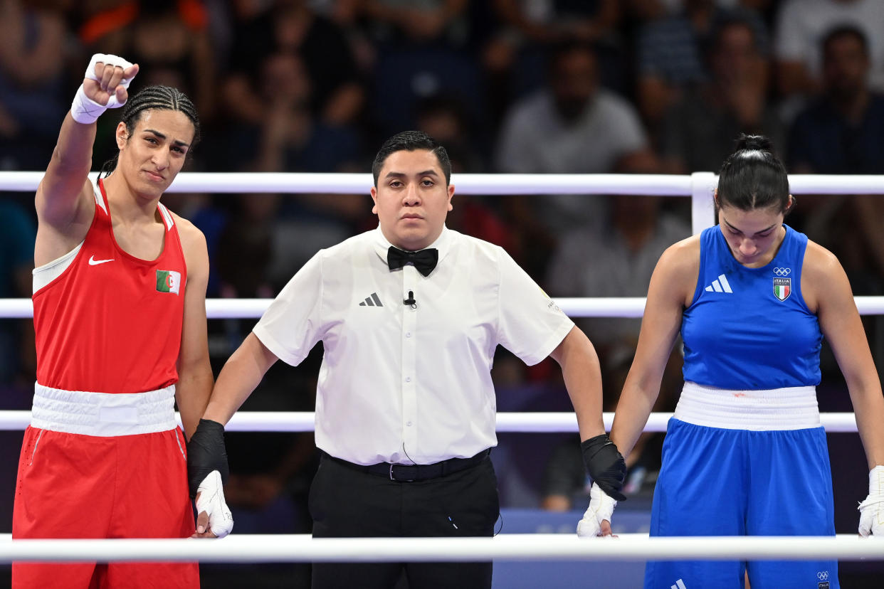 PARIS, FRANCE - AUGUST 1: Algeria's Imane Khelif (in red) during the Women's 66kg preliminary round match against Angela Carini of Italy (in blue) on day six of the Olympic Games Paris 2024 at North Paris Arena on August 01, 2024 in Paris, France. (Photo by Fabio Bozzani/Anadolu via Getty Images)