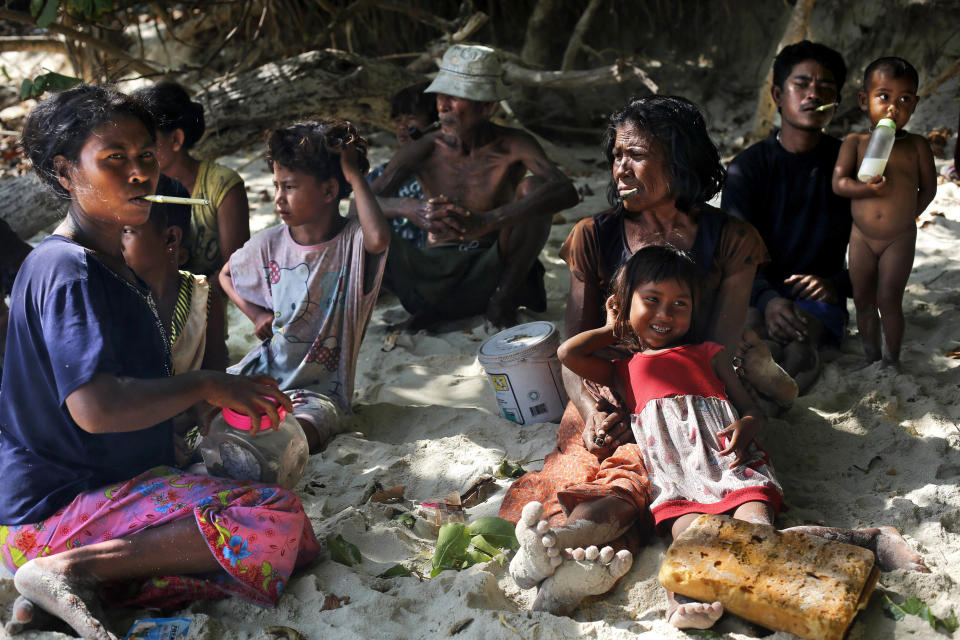 In this Sunday, Feb. 9, 2014 photo, a group of Moken families, nomads of the sea, rest in the shade of trees on Island 115 in Mergui Archipelago, Myanmar. The Moken group of several families are spending 10 days hunting for squid and whatever else they can collect before returning to their village on another island toward Myanmar’s southwestern coast with a lacework of 800 islands, what is known as the Lost World. Isolated for decades by the country’s former military regime and piracy, the Mergui archipelago is thought by scientists to harbor some of the world’s most important marine biodiversity and looms as a lodestone for those eager to experience one of Asia’s last tourism frontiers before, as many fear, it succumbs to the ravages that have befallen many of the continent’s once pristine seascapes. (AP Photo/Altaf Qadri)