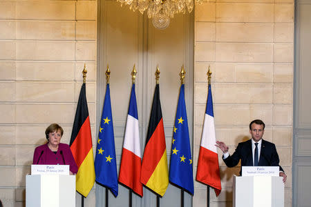 French President Emmanuel Macron and German Chancellor Angela Merkel attend a joint news conference before a meeting at Elysee Palace in Paris, France, January 19, 2018. REUTERS/Christophe Petit Tesson/Pool