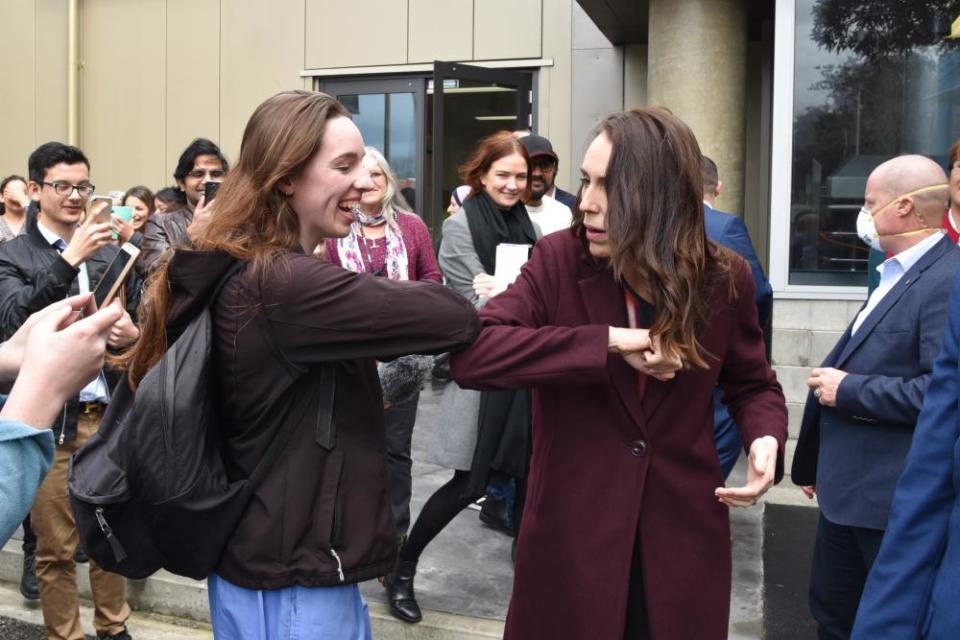 New Zealand Prime Minister Jacinda Ardern (R) greets a student at Massey University during election campaigning in Palmerston North.