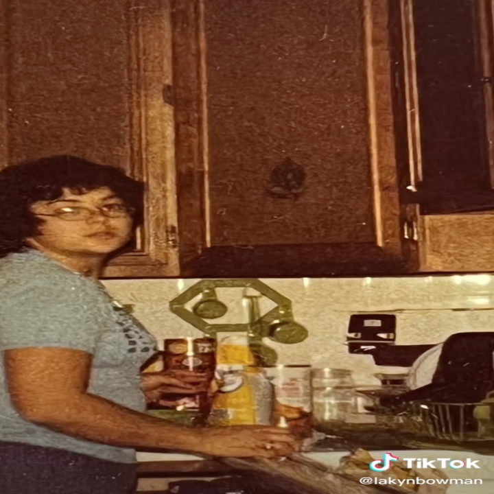 Lakyn's grandma looks at the camera while in the kitchen in a candid photo