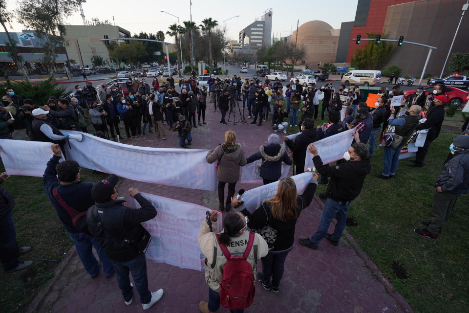 People join a national protest against the murder of journalist Lourdes Maldonado and freelance photojournalist Margarito Martínez, at the Mexico monument in Tijuana, Mexico, Tuesday, Jan. 25, 2022. Mexico's Interior Undersecretary Alejandro Encinas said recently that more than 90% of murders of journalists and rights defenders remain unresolved, despite a government system meant to protect them. (AP Photo/Marco Ugarte)