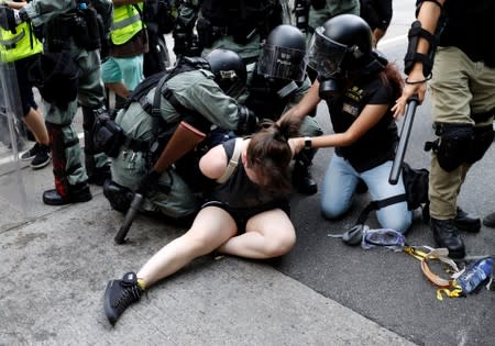 Riot police officers detain an anti-extradition bill protester during a march in Sham Shui Po neighbourhood in Hong Kong