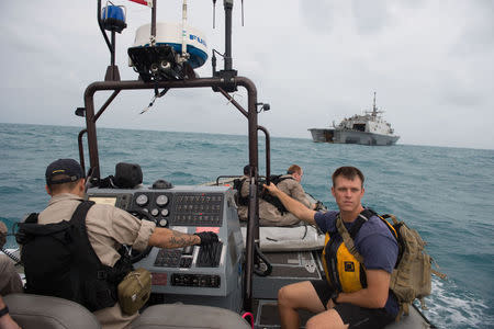 Sailors from the US Navy's USS Fort Worth searching in the Java Sea for AirAsia Flight QZ8501 make preparations to launch a Tow Fish side scan sonar system from the ship's 11-m rigid hull inflatable boat in a photo released by the US Navy January 4, 2015. REUTERS/US Navy/Mass Communication Specialist MC2 Antonio P. Turretto Ramos/Handout