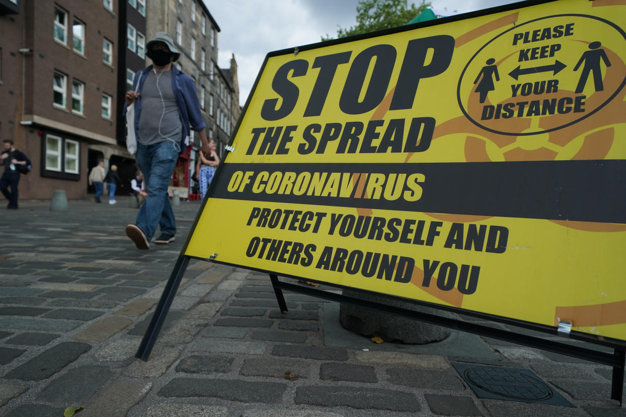 A COVID information sign in Edinburgh. Experts have warned of the need to treat COVID and flu differently. (PA)