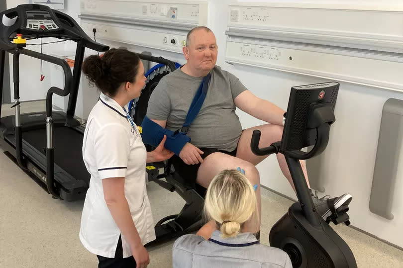 Alan Blair tries out the new specialist ‘recumbent’ bike donated to the Ulster Hospital’s Stroke Ward