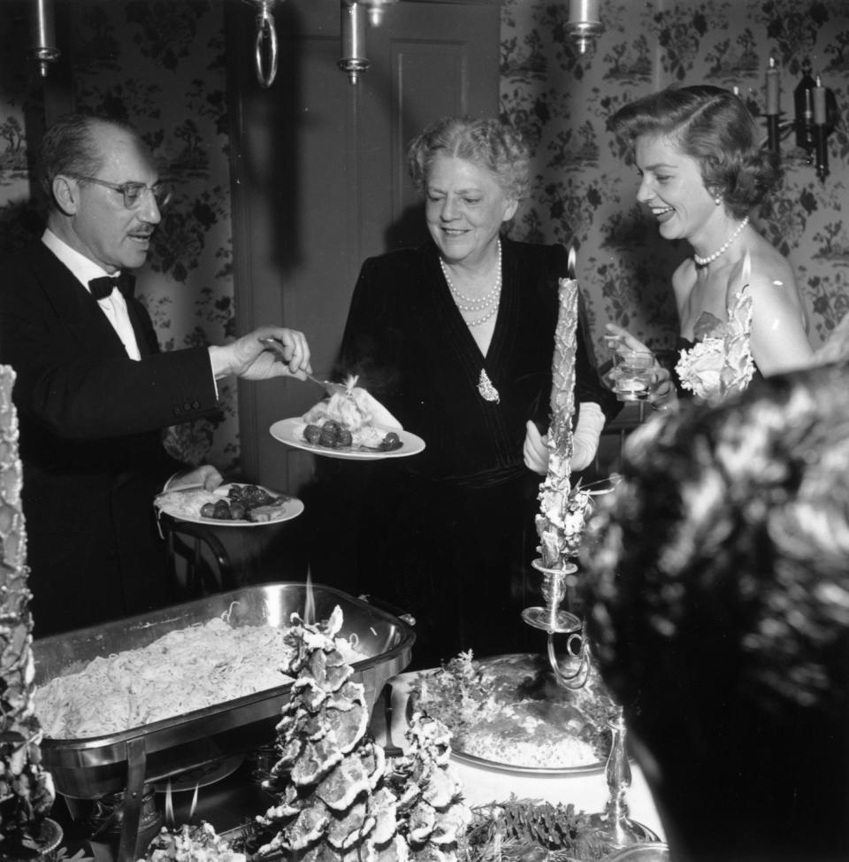 <p>The festivities continue throughout Bacall and Bogart's home as she shares dessert and laughter with Groucho Marx and Ethel Barrymore. </p>