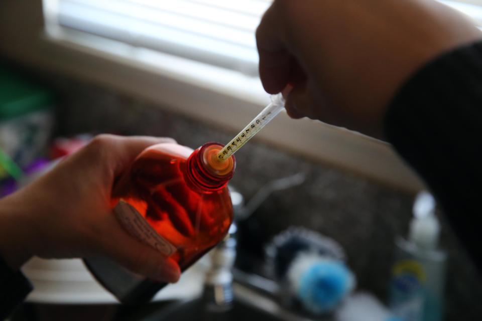 FILE - In this Feb. 7, 2014 file photo, Aileen Burger loads an oral syringe with cannabis-infused oil used to treat her 4-year-old daughter Elizabeth, who suffers from severe epilepsy, at her home in Colorado Springs, Colo. Parents of Utah children with severe epilepsy are cheering a new state law that allows them to obtain the extract, which comes from a strain of marijuana called Charlotte’s Web, and is believed to help with seizures, but it's unclear how and when they'll procure it. (AP Photo/Brennan Linsley, File)