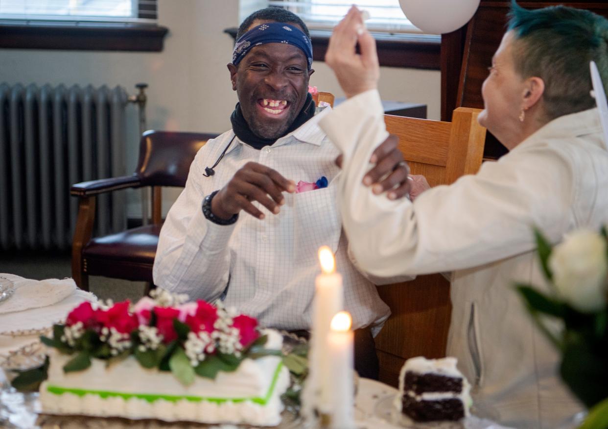 Jeffery Glenn laughs as he dodges icing after cutting his wedding cake with his wife, Christie, at Trinity United Methodist Church, January 21, 2024.