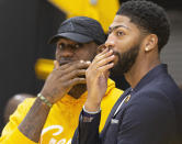 Los Angeles Lakers NBA basketball players, LeBron James, left, and Anthony Davis share a moment after David was introduced at a news conference at the UCLA Health Training Center in El Segundo, Calif., Saturday, July 13, 2019. (AP Photo/Damian Dovarganes)