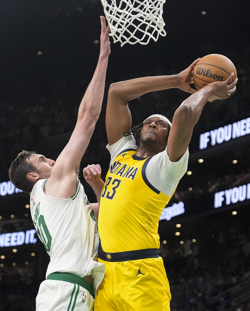 Indiana Pacers center Myles Turner (33) goes up for a shot against Boston Celtics center Luke Kornet (40) during the second quarter of Game 1 of the NBA Eastern Conference basketball finals, Tuesday, May 21, 2024, in Boston. (AP Photo/Charles Krupa)