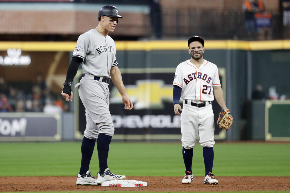 New York Yankees' Aaron Judge, left, talks with Houston Astros second baseman Jose Altuve during the third inning in Game 6 of baseball's American League Championship Series Saturday, Oct. 19, 2019, in Houston. (AP Photo/Eric Gay)