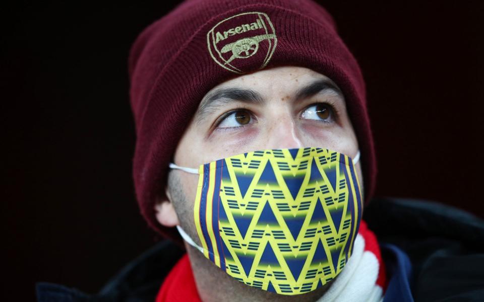 An Arsenal fan wearing a mask during his side's victory over Rapid Vienna as fans were allowed back into stadiums - GETTY IMAGES