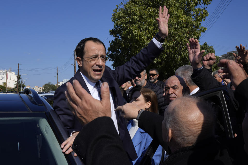 Presidential candidate Nikos Christodoulides greets his supporters after casting his vote during the presidential elections in Geroskipou in south west coastal city of Paphos, Cyprus, Sunday, Feb. 12, 2023. Voting has started in a runoff to elect ethnically split Cyprus' eighth new president, pitting a former foreign minister who campaigned as a unifier eschewing ideological and party divisions against a popular veteran diplomat. Some 561,000 citizens are eligible to vote and both Nikos Christoulides, the ex-foreign minister and Andreas Mavroyiannis are hoping for a higher turnout than the 72% that cast ballots in Feb. 5 first round. (AP Photo/Petros Karadjias)