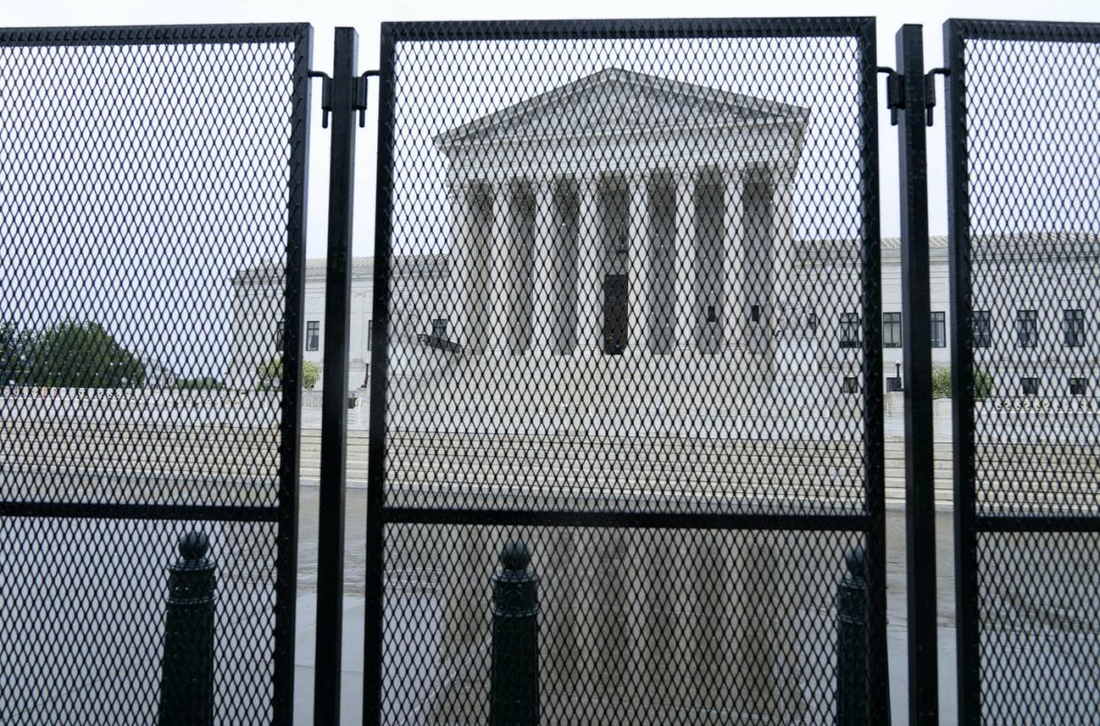 <span class="caption">An unscalable fence around the U.S. Supreme Court, on May 7, 2022, set up in response to protests against the possible overruling of Roe v. Wade.</span> <span class="attribution"><a class="link " href="https://www.gettyimages.com/detail/news-photo/an-un-scalable-fence-stands-around-the-us-supreme-court-in-news-photo/1240520345?adppopup=true" rel="nofollow noopener" target="_blank" data-ylk="slk:Jose Luis Magana / AFP/Getty Images;elm:context_link;itc:0;sec:content-canvas"> Jose Luis Magana / AFP/Getty Images</a></span>