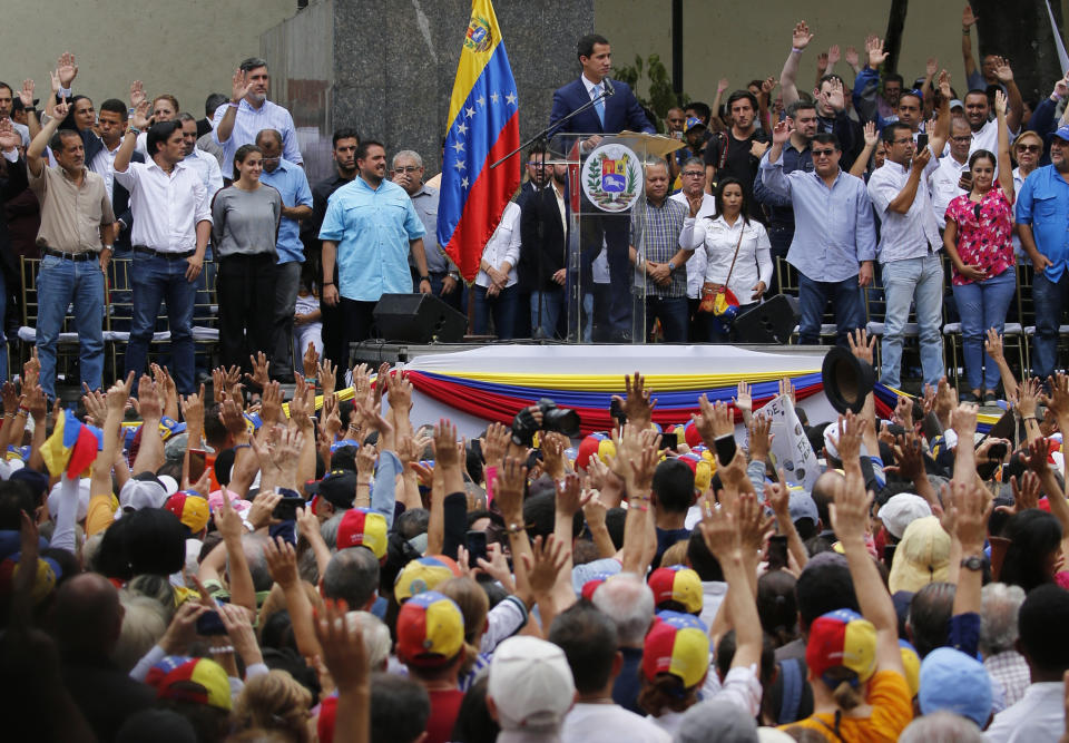 Juan Guaido, opposition leader and self-proclaimed interim president of Venezuela, leads an outdoor, town hall-style meeting in Plaza Bolivar in the Chacao area of Caracas, Venezuela, Friday, April 19, 2019. The opposition held the forum to announce a new strategy against the government of President Nicolas Maduro. (AP Photo/Fernando Llano)